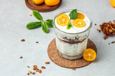 Kumquat chia pudding yogurt on a light background. healthy breakfast. banner, menu, recipe place for text, top view.