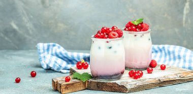raspberries yogurt. Healthy breakfast Greek yogurt with raspberries and mint in a glass. Berry smoothie. healthy dieting concept. Long banner format.