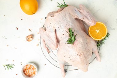 raw duck with orange thyme and spices on a light background, Culinary cooking. banner, menu, recipe place for text, top view.