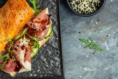 Sandwich with Jamon Serrano and spinach, Cured ham, spanish appetizer. Healthy food concept. place for text, top view.