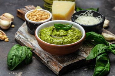 Green basil pesto with italian recipe ingredients, Basil, olive oil, parmesan, garlic, pine nuts. banner, menu, recipe place for text, top view,