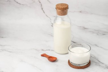 A bottle of milk and glass of yogurt, kefir, fermented milk, Probiotic cold fermented dairy drink. top view,