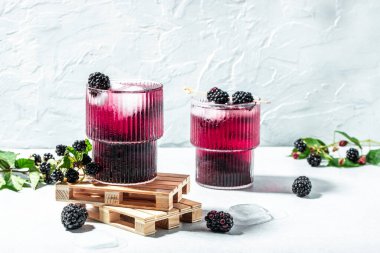 Refreshing lemonade with blackberry on a light background. top view. place for text,
