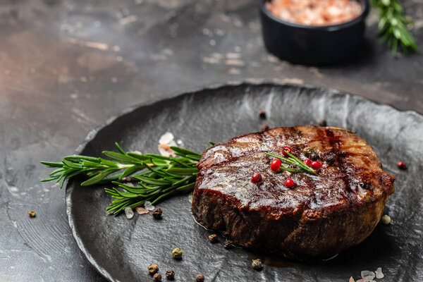 steak roasted on the grill on a dark background. Healthy food concept. place for text, top view,