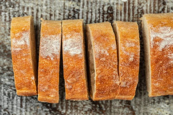 Fresh bread. Texture of sliced loaf of bread Italian ciabatta. Food recipe background. Close up.