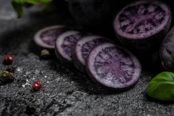 Raw purple sweet potato food . Fresh potatoes in an old sack on wooden background. Batata potato. vegan food ingredient. banner, menu, recipe place for text, top view.