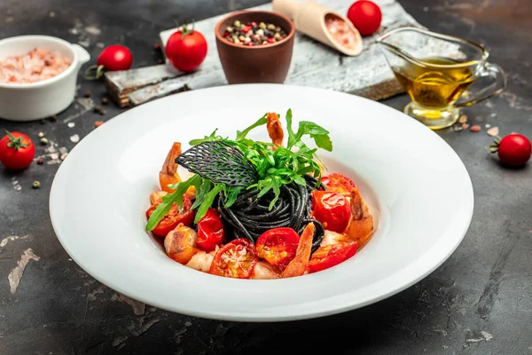 black pasta with shrimp and cherry tomatoes. Delicious balanced food concept, banner, menu, recipe place for text, top view,