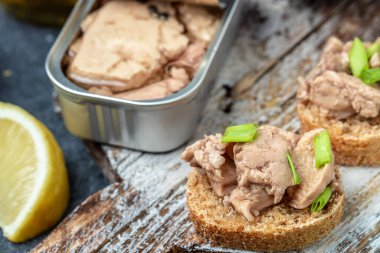 Cod liver over brown bread with green onion, Food recipe background. Close up,