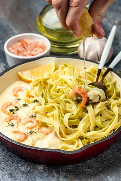 Pasta with Shrimp and bechamel sauce in a pan. Food recipe background. Close up.