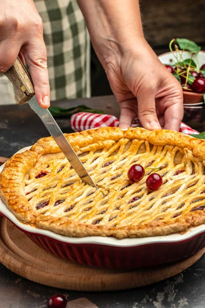 Delicious Homemade Cherry Pie, Flaky Crust, piece on a plate and the whole homemade cherry pie, place for text, top view,