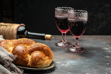 Shabbat Shalom challah bread, shabbat wine on a dark background, place for text, top view, clipart
