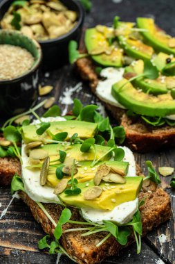 Peynirli, kabaklı, fındıklı ve susamlı avokado tostu. Sağlıklı yağlar, kilo vermek için temiz yiyecekler..