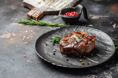 grilled meat barbecue steak on a wooden board. banner, menu, recipe place for text, top view.