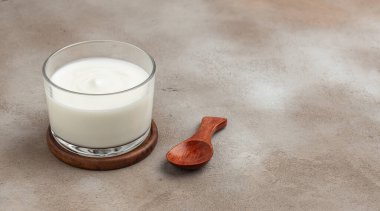 Creamy natural yogurt on a light background, Probiotic cold fermented dairy drink. Long banner format. top view,