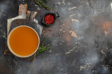 Broth in Bowl with meat pork knuckle on a dark background, Long banner format. top view.