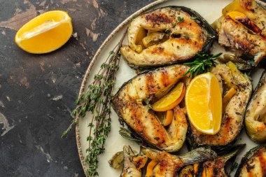 Sturgeon steaks. Grilled fish on a dark background, Restaurant menu, dieting, cookbook recipe top view.