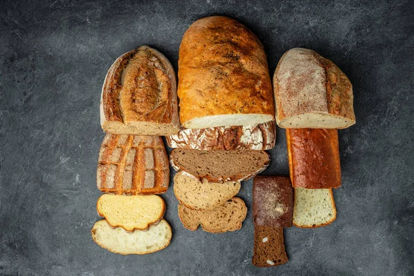 Homemade fresh baked various loafs of wheat and rye bread. banner, menu, recipe place for text, top view.