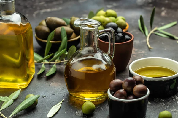 stock image Mixed types of olive in the bowls and olive oil on a dark background, banner, menu, recipe place for text, top view,