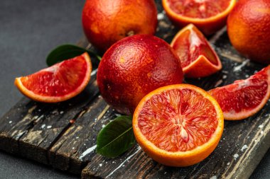 Blood oranges on a wood background. banner, menu, recipe place for text, top view. clipart