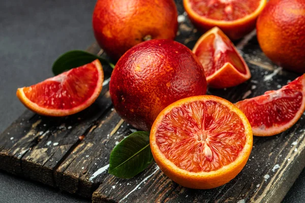 Blood oranges on a wood background. banner, menu, recipe place for text, top view.