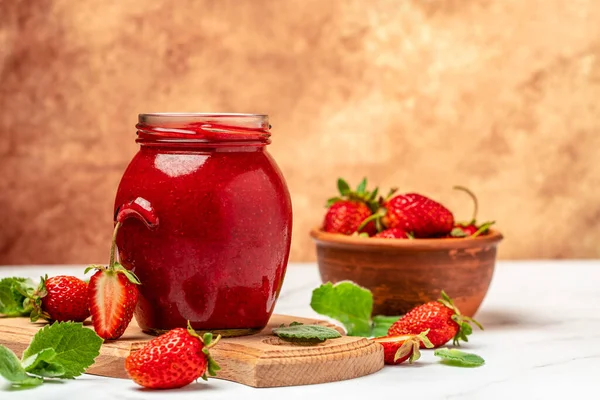 stock image strawberry jam in a jar and fresh berries on white table. banner, menu, recipe place for text.