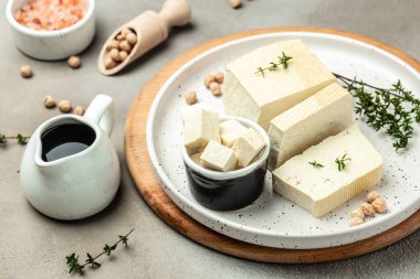 soy cheese tofu diced on a light background, Healthy vegan meatless meal rich in protein and calcium. Food recipe background. Close up,