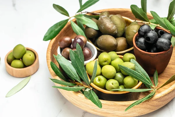 stock image Mixed types of olive in the bowls and olive oil on a light background, banner, menu, recipe place for text, top view,