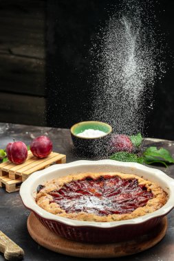 plum cake, powdered sugar is sprinkled on the cake Culinary, cooking, bakery concept. banner, menu, recipe place for text,