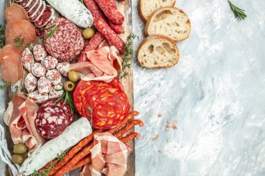 Antipasto meat board. catering platter with bacon, jamon, sausage and wine. Food recipe background. Close up.