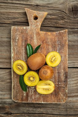Closeup ripe golden kiwi fruit. Food background. vertical image. top view. place for text.