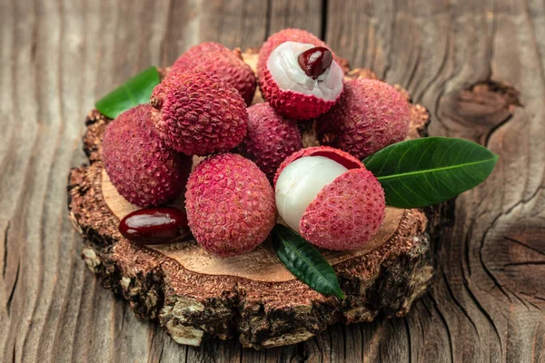 stock image Fresh ripe lychee fruit and peeled lychee on a wooden background. banner, menu, recipe, top view.