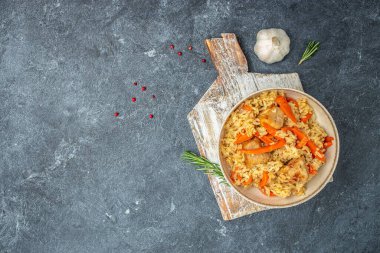 plate of pilaf. traditional Uzbek dish. rice with vegetables. banner, menu, recipe place for text, top view.
