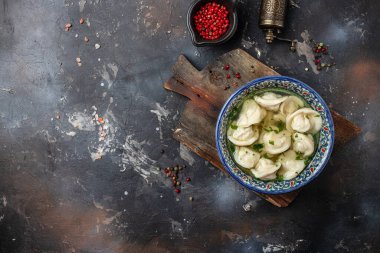 Dumplings in the soup chuchvara banner, menu, recipe place for text, top view. Uzbek cuisine.