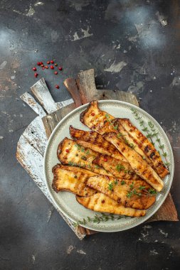 Grilled King oyster mushrooms with thyme on plate. Food recipe background. Close up.