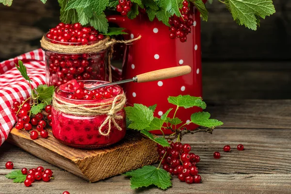 red currant jam in jar. Canned fresh berries on a wooden background. banner, menu, recipe place for text.