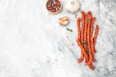 small dty Salami sausages on a light background. Long banner format. top view.