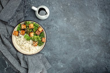 Savory sauteed mixed chinese rice, broccoli with fried tofu, Asian vegan bowl, Long banner format. top view,