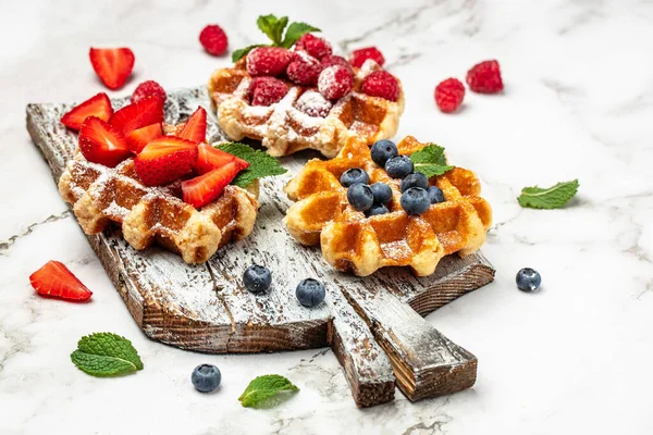 belgian waffles. Berry Belgian Waffle with raspberries, strawberries and blueberries. Delicious breakfast or snack.