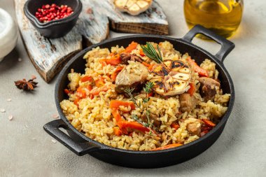 Uzbek food pilaf in cast-iron pan. banner, menu, recipe place for text.
