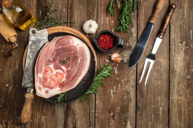 Raw ham cut, pork leg on a wooden background, banner, menu, recipe place for text, top view,