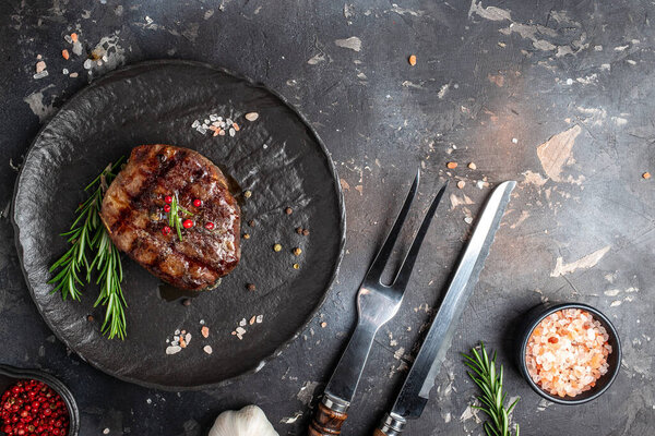 steak roasted on the grill on a dark background. Healthy food concept. place for text, top view,