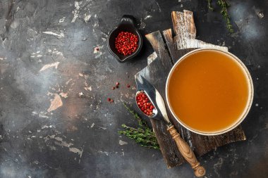 Broth in Bowl with meat pork knuckle on a dark background, Long banner format. top view.