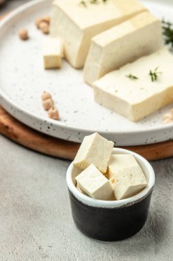 soy cheese tofu diced on a light background, Healthy vegan meatless meal rich in protein and calcium. Food recipe background. Close up,