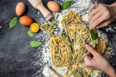 Fresh pasta being rolled and sliced. banner, menu, recipe place for text, top view. clipart