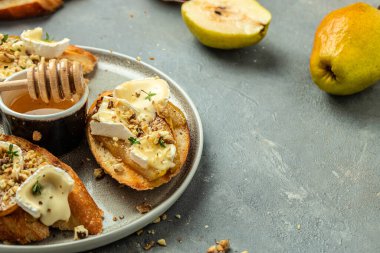 Sweet toast with pear, cheese and honey. party appetizer. banner, menu, recipe place for text, top view.