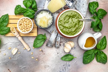 bowl with green pesto pine nuts, parmesan and garlic. Food recipe background. Close up.