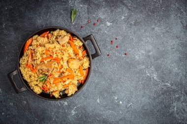 Uzbek pilaf in cast-iron pan. banner, menu, recipe place for text, top view.