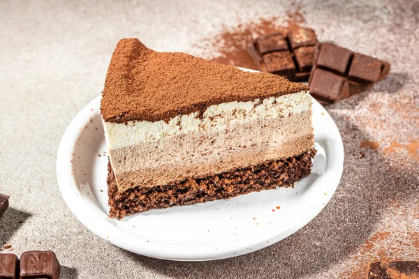 piece of Cake, three of chocolate, Mousse cake three chocolate on a light background,