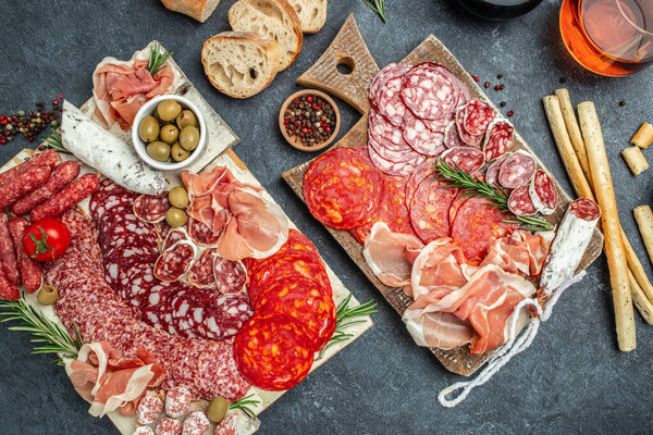 Cold meat plate Italian snacks food with ham, prosciutto, salami, pork chops, sausage and grissini bread sticks, catering banner, menu, recipe,
