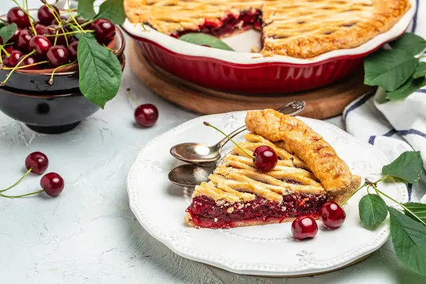 stock image Delicious Homemade Cherry Pie, Flaky Crust, piece on a plate and the whole homemade cherry pie, top view,